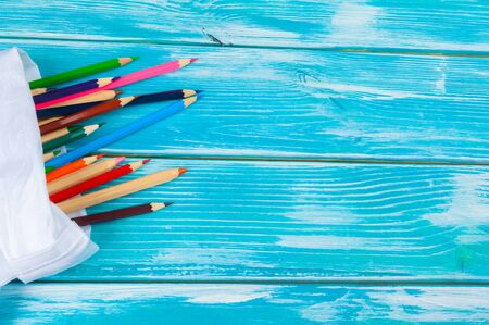 Colorful pencils on a bright blue wooden backgroundの写真素材