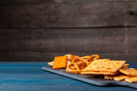 wide selection of snacks for beer on wooden background