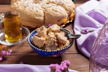 Tasty halva with tea on the table. creative photo.