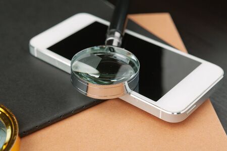 Conceptual image depicting conducting an online search for information with a magnifying glass. creative photo.の写真素材