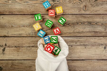 Letters background. Wooden cubes with letters on wooden background. creative photo.