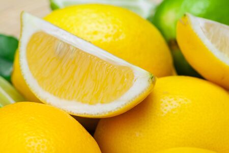 fresh lemons on wooden table. close up. creative photo.の写真素材