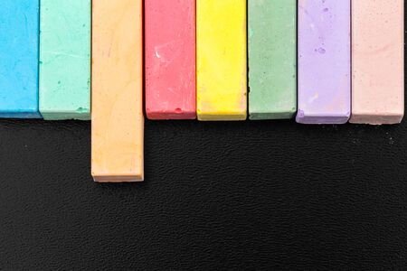 Set of colored chalks over a black backgroundの写真素材