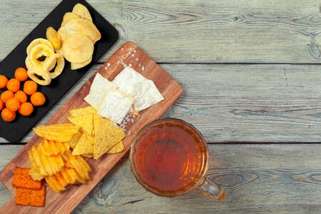 Lager beer and snacks on wooden table. creative photo.の写真素材