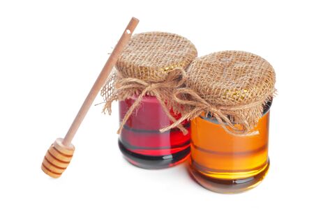 Glass jar with sweet honey isolated on white background. creative photo.の写真素材
