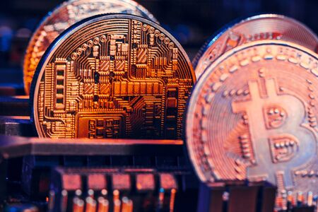 golden bitcoin and computer chip in background. creative photo.の写真素材