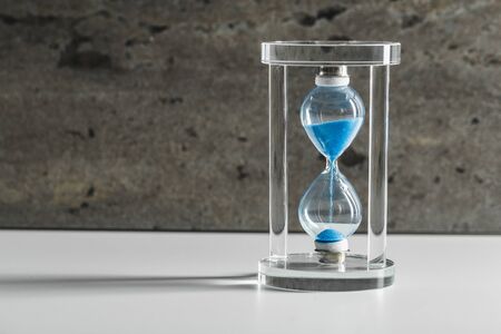 Hourglass on dark background. creative photo.