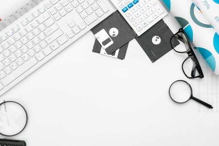magnifying glass inspecting on floppy disk concept