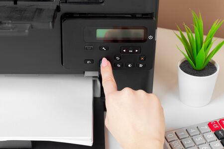 Woman using the printer to scanning and printing documentの写真素材