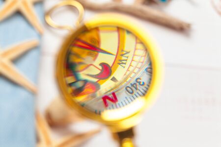 Compass on white wooden table backgroundの写真素材