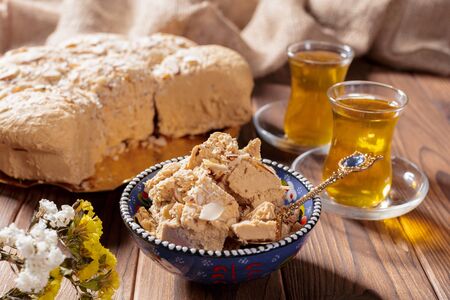 Tasty halva with tea on the table. creative photo.