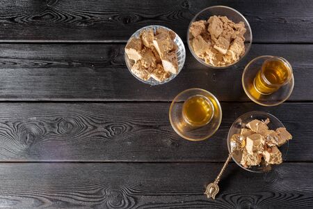 Tasty halva with tea on the table. creative photo.