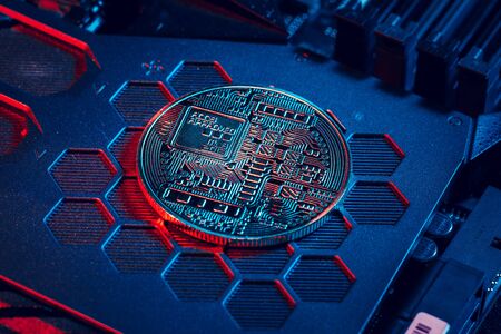 golden bitcoin and computer chip in background. creative photo.の写真素材