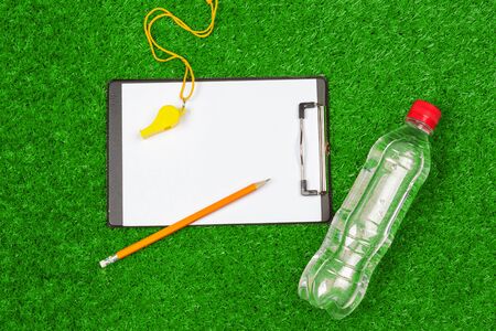 Sheet of paper and sports equipment on grass close-up. creative photo.の写真素材