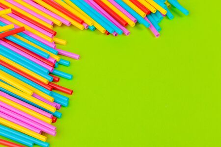 Colorful straws for beverage soft drink on colored background creative photo.