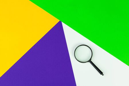Magnifying glass on bright colored background flat lay creative photo.の写真素材
