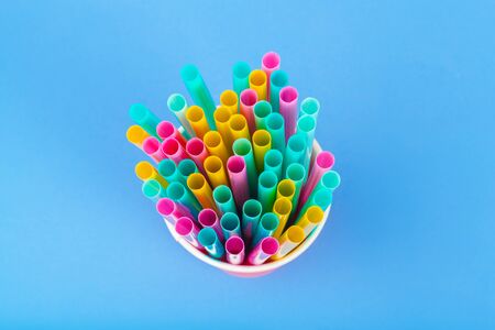 Colorful straws for beverage soft drink on colored background creative photo.の写真素材
