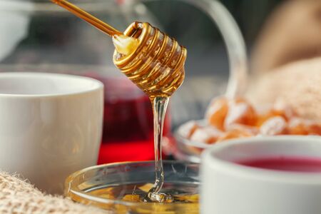 Cup with herbal tea and honey and dry herbal teaの写真素材
