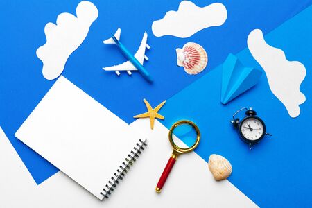 Paper plane on a blue background with clouds creative photo.の写真素材