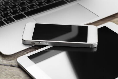 Open laptop with digital tablet and smartphone close up creative photo.の写真素材