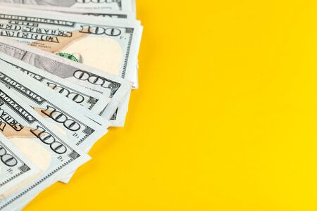 US dollar money cash on yellow background. creative photo.