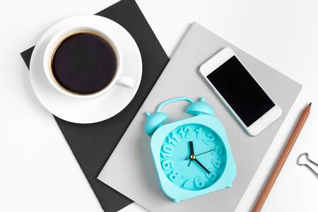 Smartphone and coffee cup, notepad close up top viewの写真素材