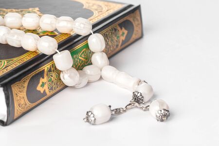 Islamic Book Holy Quran and beads on withe backgroundの写真素材