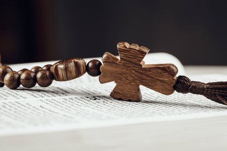 Bible and a crucifix on an old wooden table. Religion concept.の写真素材