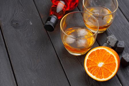 Whiskey and whiskey stones on a wooden table creative photo.の写真素材