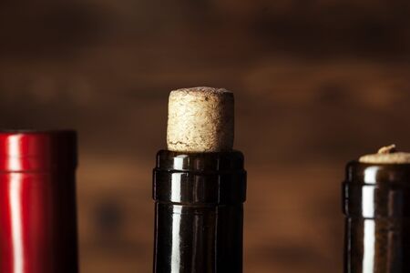 bottle of wine over wooden background creative photo.の写真素材