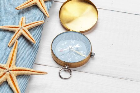 beautiful sea composition with shells and vintage compass creative photo.