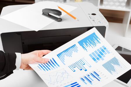 Woman using the printer to scanning and printing document. creative photo.の写真素材