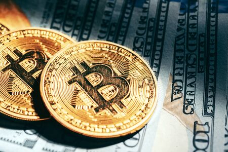 Golden bitcoin coins on a paper dollars money. creative photo.