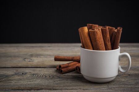 Cinnamon sticks on wooden background.の写真素材