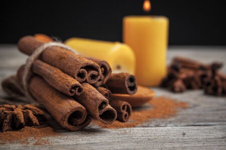 Cinnamon sticks on wooden background.の写真素材