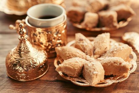 Turkish sweets with coffee on a wooden table. creative photo.の写真素材