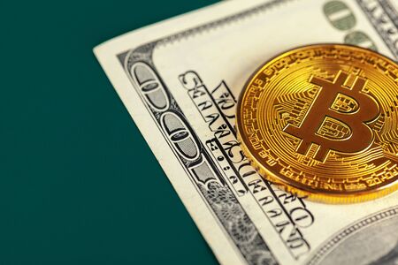 Golden bitcoin and dollars close up. creative photo.の写真素材