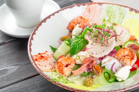 Fresh seafood salad served with prawns and greensの写真素材