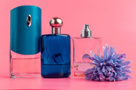 Perfume bottles on pastel pink background close upの写真素材