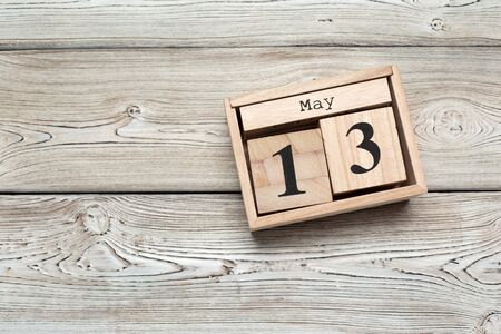 cube calendar for may 13th on wood with copy space. Close up.