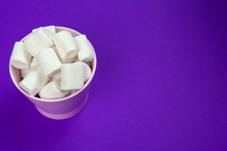 marshmallow laid out on violet paper background. Close up.の写真素材