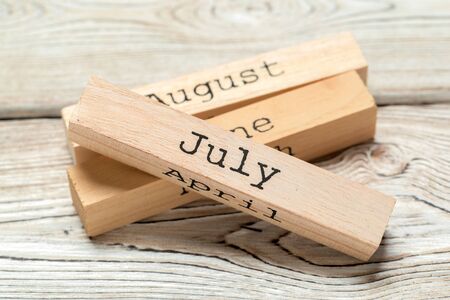 top view of parts of wooden calendar on dark wooden tabletop. Close up.の写真素材