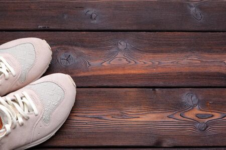 sneakers on old retro wooden background. Close up.