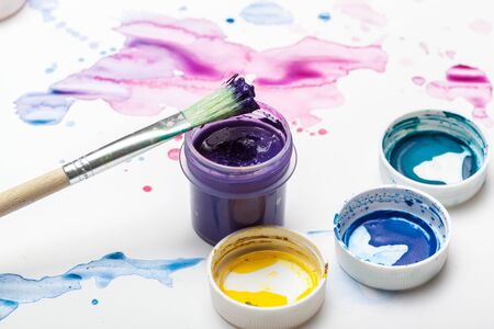 splashes of watercolor paint and painting suppliesの写真素材