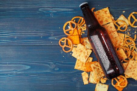 A selection of beer and snacks on wooden background. Close up.の写真素材