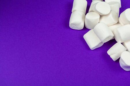 marshmallow laid out on violet paper background. Close up.の写真素材