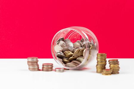 Business concept, saving planning with coins in glass jar. Close up.