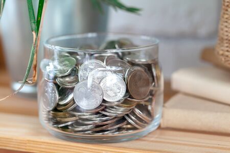 Business concept, saving planning with coins in glass jar. Close up.