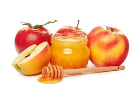 Apples and honey jar for jewish new year holiday isolated on white backgroundの写真素材