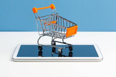 Empty grocery toy shopping cart on a table. Close up.の写真素材